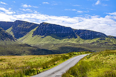 Narrow road running through the rugged hills of the Trotternish escarpment on the northernmost peninsula of the Isle of Skye, Inner Hebrides, Scotland.