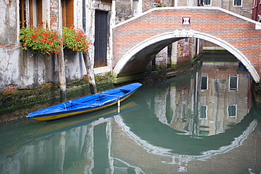 Bridge over canal with boat and buildings, Venice, Italy