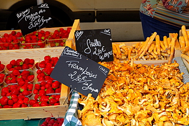 Mushrooms and strawberries on a market stall, France, Europe