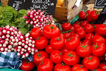 Radishes and tomatoes on a market stall, France, Europe