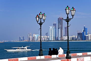 City skyline and the famous Corniche looking across the harbour from a pier, Abu Dhabi, United Arab Emirates, Middle East