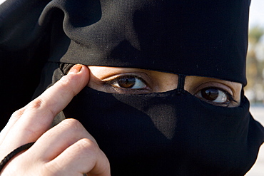 Woman wearing traditional veil, Doha, Qatar, Middle East