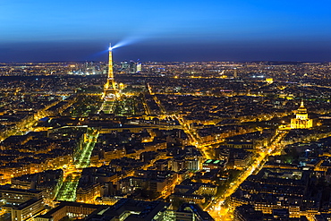 Elevated view of the Eiffel Tower, city skyline and La Defense skyscraper district in the distance, Paris, France, Europe