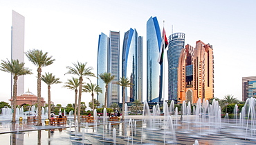 Etihad Towers viewed over the fountains of the Emirates Palace Hotel, Abu Dhabi, United Arab Emirates, Middle East