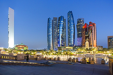 Etihad Towers viewed over the fountains of the Emirates Palace Hotel, Abu Dhabi, United Arab Emirates, Middle East