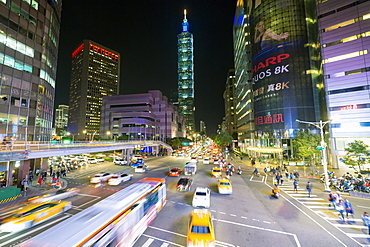 Traffic in front of Taipei 101 at a busy downtown intersection in the Xinyi district, Taipei, Taiwan, Asia