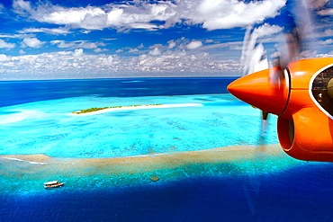 Aerial view of island and seaplane, Male Atoll, The Maldives, Indian Ocean, Asia