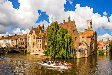 Tour boat on Rozenhoedkaai canal with Belfort tower, Bruges, UNESCO World Heritage Site, West Flanders, Belgium, Europe