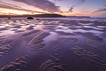 Pink sunrise skies in winter above the sandy beach at Bigbury-on-Sea, South Hams, Devon, England, United Kingdom, Europe