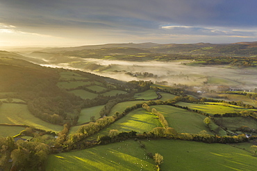 Aerial vista by drone of rolling countryside at dawn in winter, Devon, England, United Kingdom, Europe