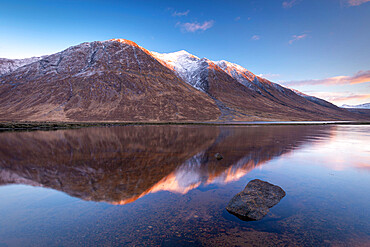 Snow capped Highlands mountains reflected in the calm waters of Loch Etive in winter, Highlands, Scotland, United Kingdom, Europe