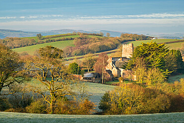 Church of St. John the Baptist at Holcombe Burnell Barton, surrounded by countryside in winter, Longdown, Devon, England, United Kingdom, Europe