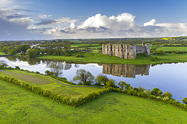 Carew Castle reflected in the mill pond on a still spring morning, Pembrokeshire Coast National Park, Wales, United Kingdom, Europe