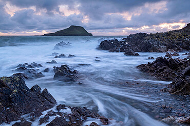 Worm's Head at high tide from the rocky seashore near Rhossili, Gower Peninsula, Wales, United Kingdom, Europe