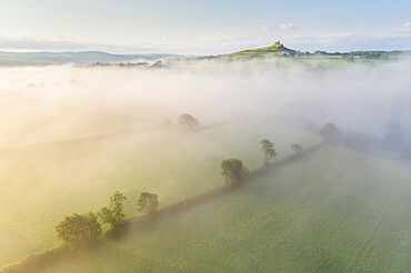 Aerial view over mist shrouded countryside towards Brentor Church, Dartmoor National Park, Devon, England, United Kingdom, Europe