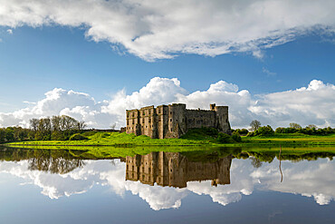 The magnificent ruins of Carew Castle reflected in the Mill Pond in spring, Carew, Pembrokeshire, Wales, United Kingdom, Europe