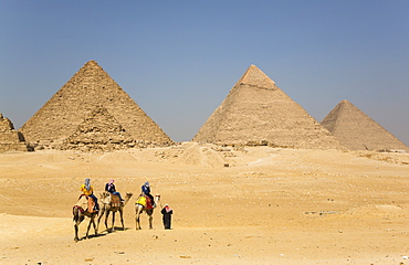 Tourists riding camels, Great Pyramids of Giza, UNESCO World Heritage Site, Giza, Egypt, North Africa, Africa