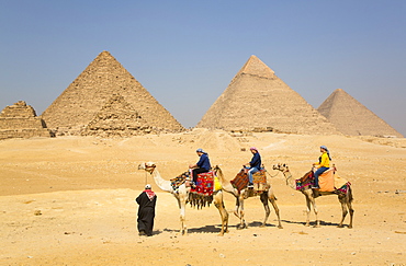 Tourists riding camels, Great Pyramids of Giza, UNESCO World Heritage Site, Giza, Egypt, North Africa, Africa