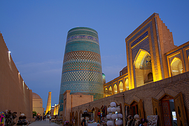 Evening, Kalta Minaret on left, Muhammad Amin Khan Madrasah (Orient Star Hotel) on the right, Ichon Qala (Itchan Kala), UNESCO World Heritage Site, Khiva, Uzbekistan, Central Asia, Asia