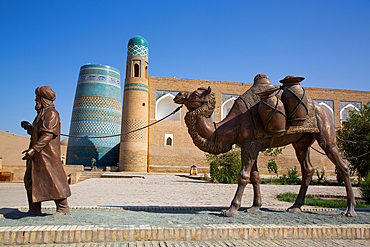 Sculpture of Camel Train, Kalta Minaret in the background, Ichon Qala (Itchan Kala), UNESCO World Heritage Site, Khiva, Uzbekistan, Central Asia, Asia