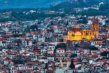 Evening overview, with illuminated Church of Santa Prisca de Taxco, Taxco, Guerrero, Mexico, North America