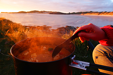Cooking over a camp stove near Balnakeil Bay, Sutherland, Highlands, Scotland, United Kingdom