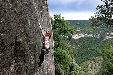 A woman climbing on limestone cliffs near Siurana, a medieval village near Reus and Barcelona, Catalonia, Spain, Europe