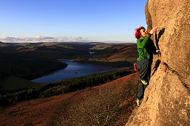 a climber on the gritstone cliffs above the Derwent Reservoir, Peak District, Derbyshire, England, United Kingdom, Europe