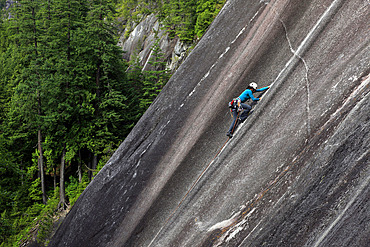 A climber scales cliffs at Squamish Chief, Squamish, British Columbia, Canada, North America