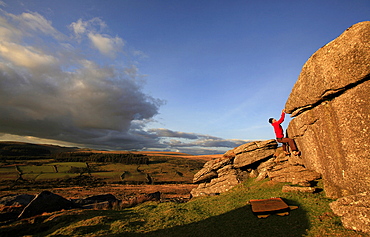 A climber bouldering on Dartmoor, Devon, England, United Kingdom, Europe