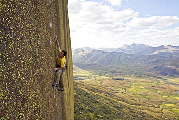 A climber scales cliffs in the Tsaranoro Massif, Madagascar, Africa