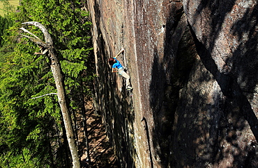 A climber scales cliffs at Bohuslan, Sweden, Scandinavia, Europe