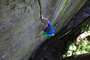 A climber soloing a difficult crack climb, Squamish Chief, Squamish, British Columbia, Canada, North America