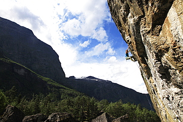 A woman climbs an overhanging route in Romsdal, near Alesund, western Norway, Scandinavia, Europe