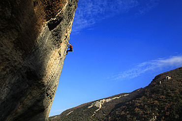 A climber scales cliffs at Buoux, Provence, France, Europe