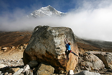 A climber tackles a difficult boulder problem on the glacial moraine at Tangnag, near Mera Peak and Mount Everest, Khumbu Region, Nepal, Himalayas, Asia