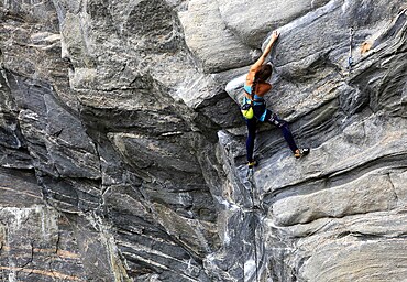 A climber scales a difficult route in the Hanshallaren Cave, Flatanger, Norway, Scandinavia, Europe