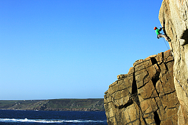 Rock climber in action on the cliffs of Sennen, Cornwall, England, United Kingdom, Europe