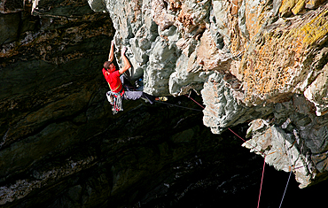 A rock climber in action on an extreme route on the cliffs of Gogarth, Anglesey, Wales, United Kingdom, Europe