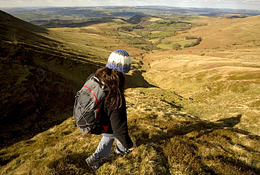 A hiker enjoys solitude in the hills above Hay-on-Wye, on the eastern edge of the Brecon Beacons National Park, Monmouthshire, Wales, United Kingdom, Europe