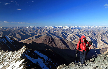 A climber makes her way up the summit ridge of Stok Kangri at 6137 metres, a popular and easily accessible trekking peak in the northern Zanskar Range, Ladakh, India, Asia