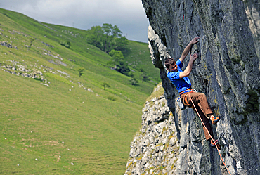 Rock climber in action, Yorkshire Dales National Park, North Yorkshire, England, United Kingdom, Europe