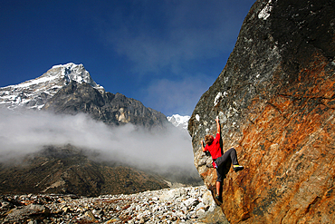 Climber bouldering at Tangnag moraine, Khumbu, Himalayas, Nepal, Asia