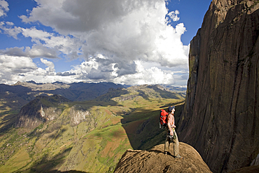 Climber looks across the Tsaranoro Massif, southern Madagascar, Africa