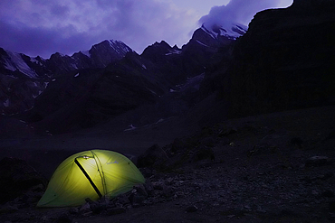 Trekker's tent lit inside at night in the remote and spectacular Fann Mountains, part of the western Pamir-Alay, Tajikistan, Central Asia, Asia