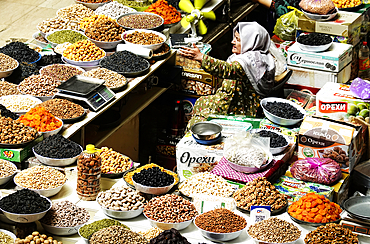 Woman selling nuts and dried fruit on a stall in the Central Market, Dushanbe, Tajikistan, Central Asia, Asia