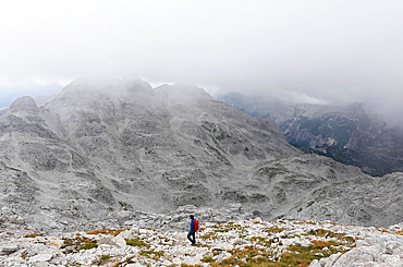 Hiker on Maja JezercA?, standing at 2,694 metres (8,839 ft) above the Adriatic, the highest peak in the high Dinaric Alps, Albania