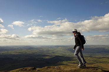 A hiker walks north from Hay Bluff, above Hay-on-Wye, Brecon Beacons National Park, Herefordshire, England, United Kingdom