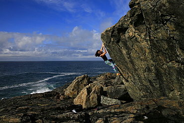 Climber bouldering near St Ives, Cornwall