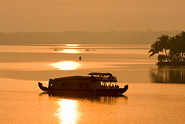 Houseboat at dusk in Ashtamudi Lake, Kollam, Kerala, India, Asia